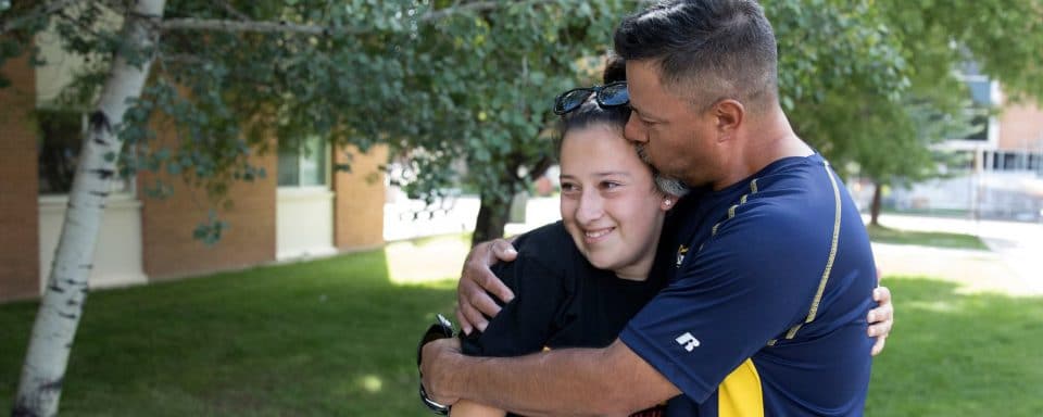 An NAU parent kisses his daughter during move-in.