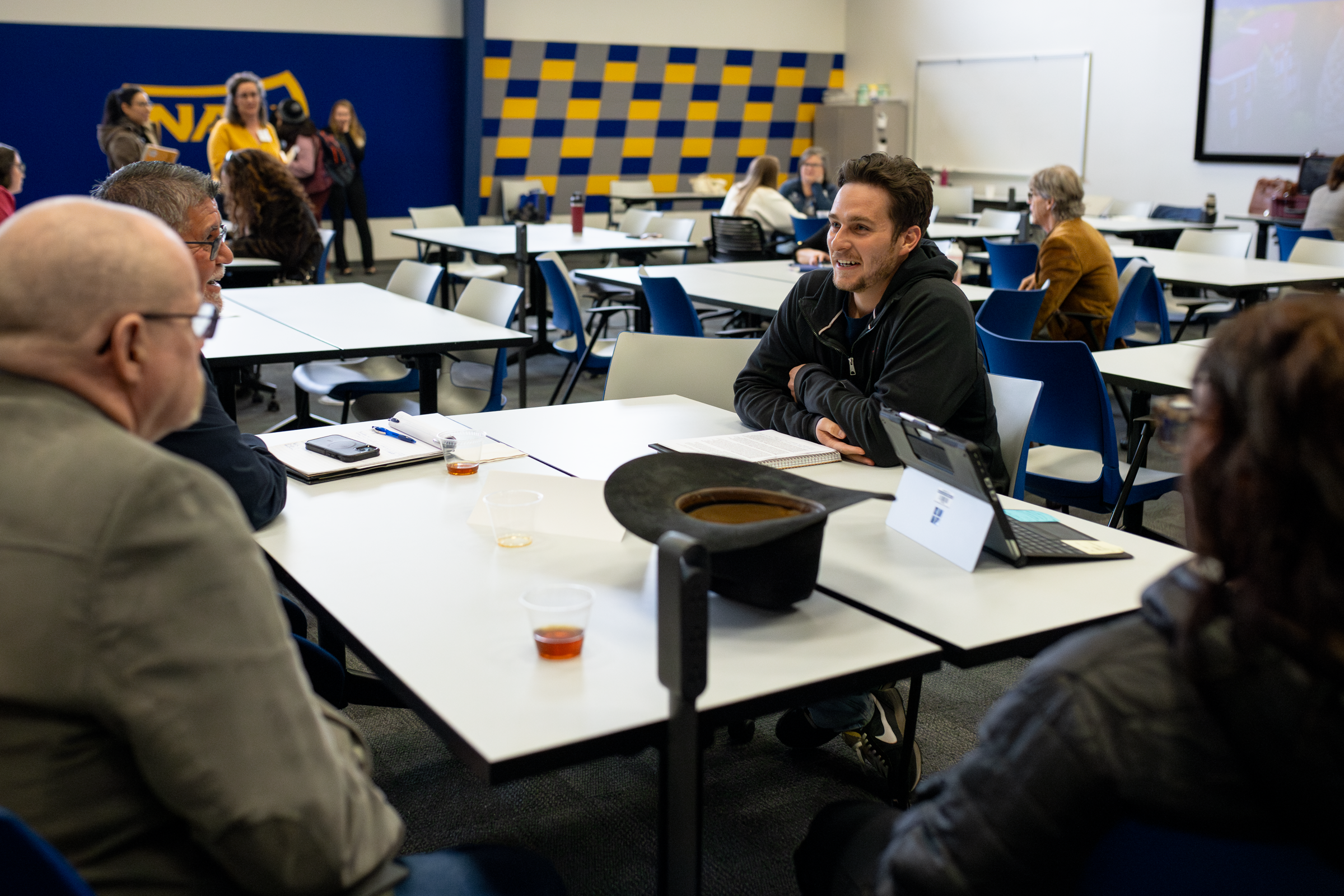 Guests talk at tables at C-CART conference.