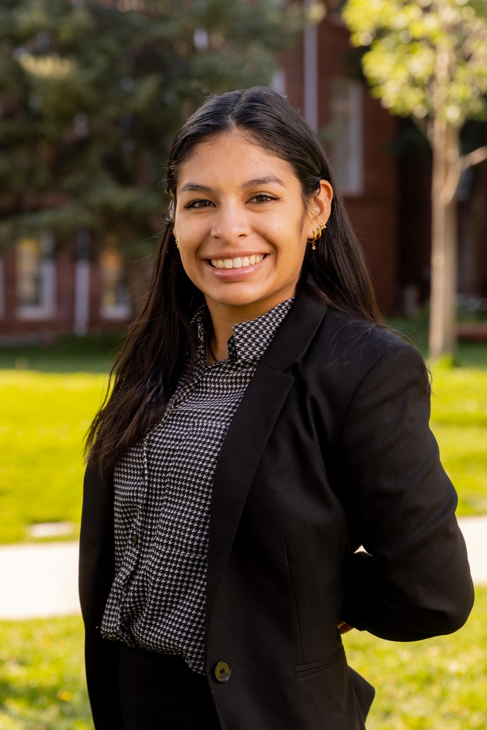 Ana standing in front of old main smiling