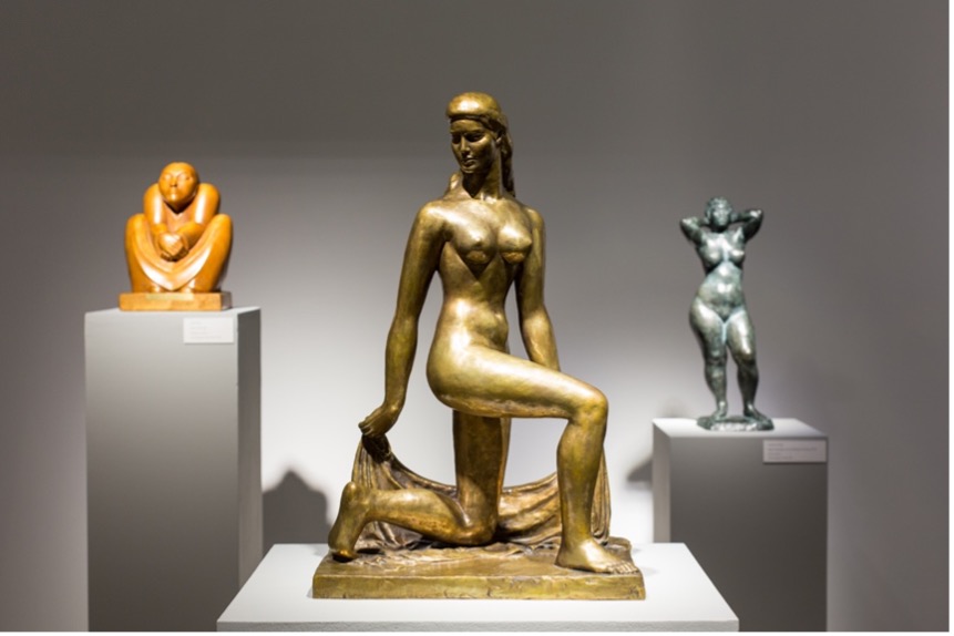 Three statues of human figures.