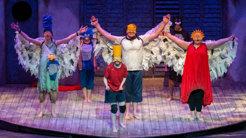 Students on stage ressed in Sumpsons costumes and bowing