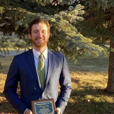 Andraws poses with his award outside of the Riles Building