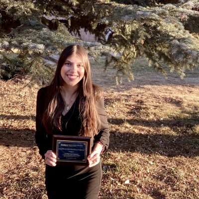 Yulissa poses with her award outside of the Riles Building.