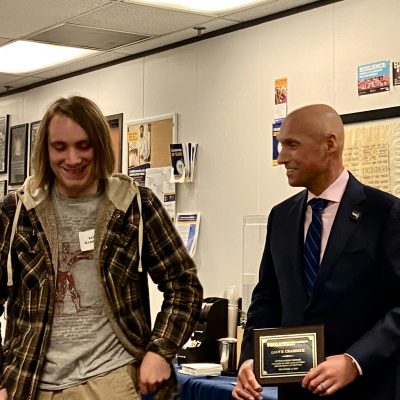 Liam poses fopr a photo while receiving his award from Dean Boyer.
