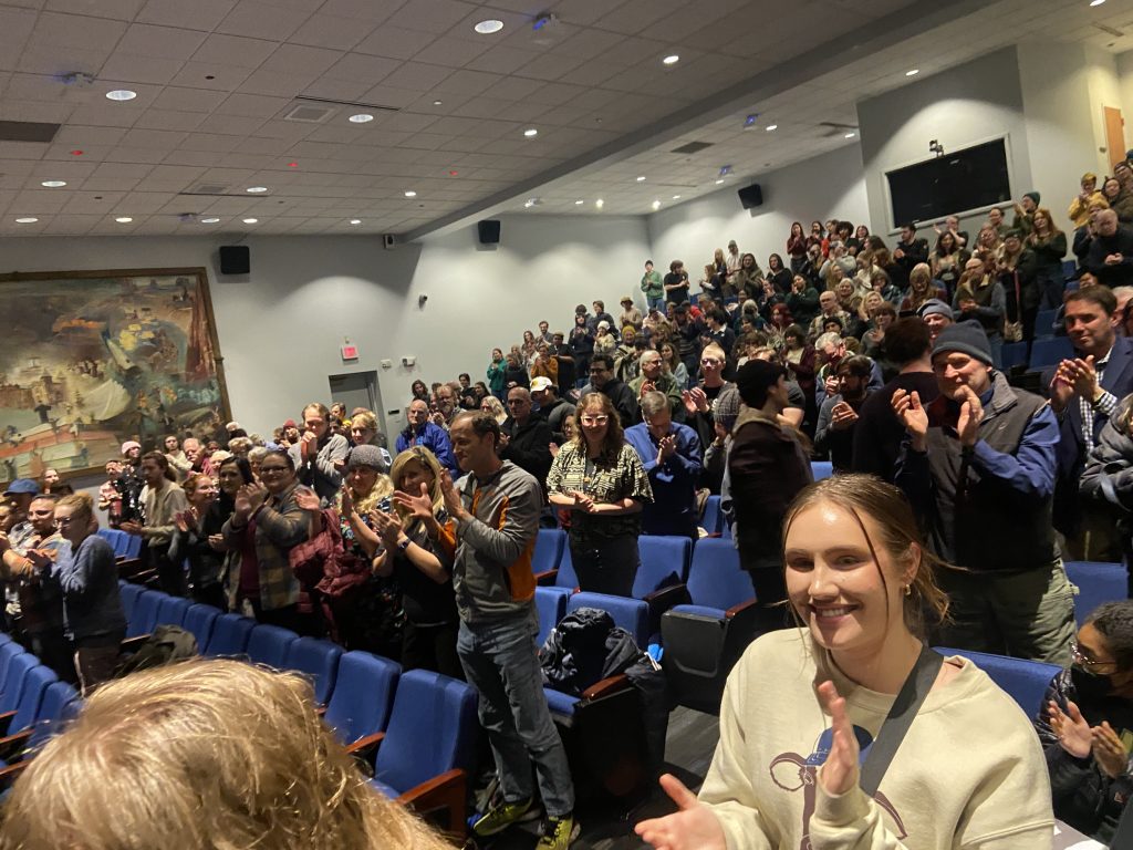 Crowd of people clapping in Cline Assembly hall