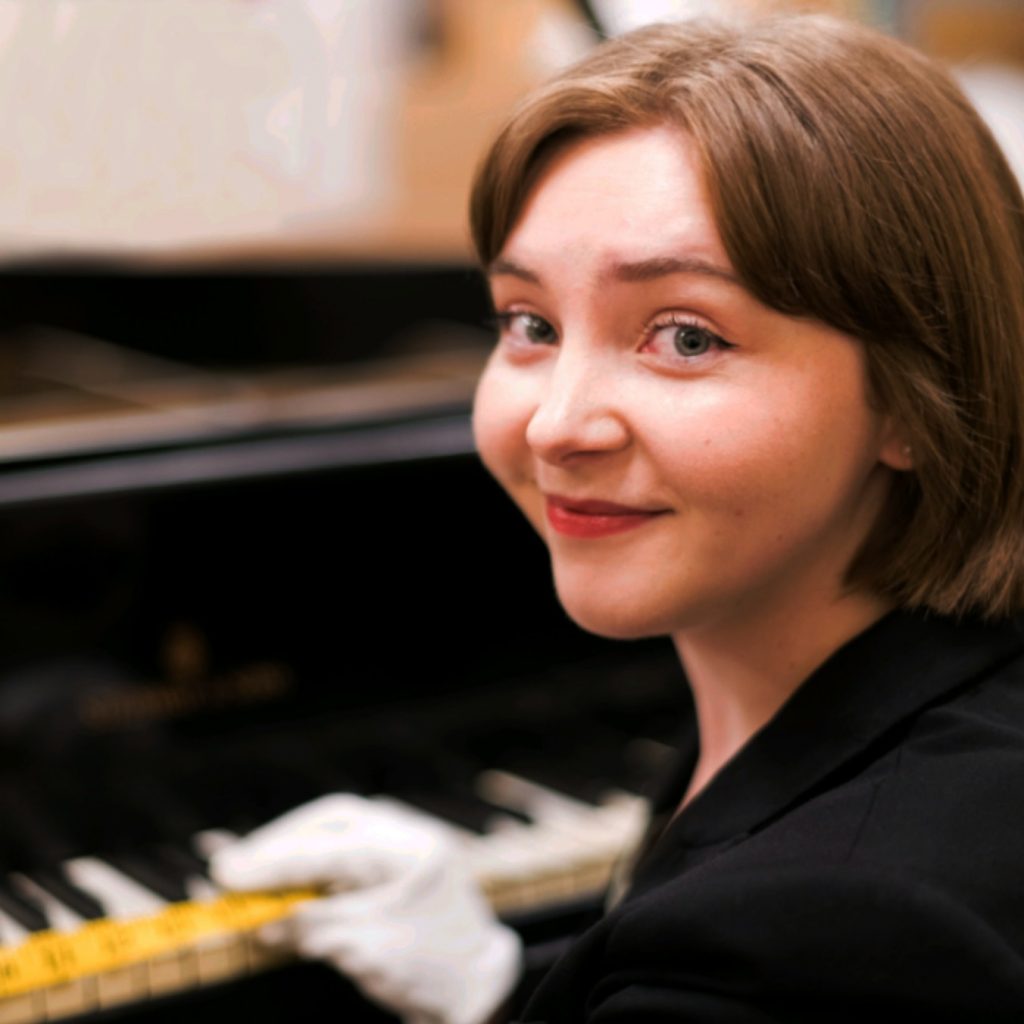 Terra wears white gloves while preparing a museum exhibit