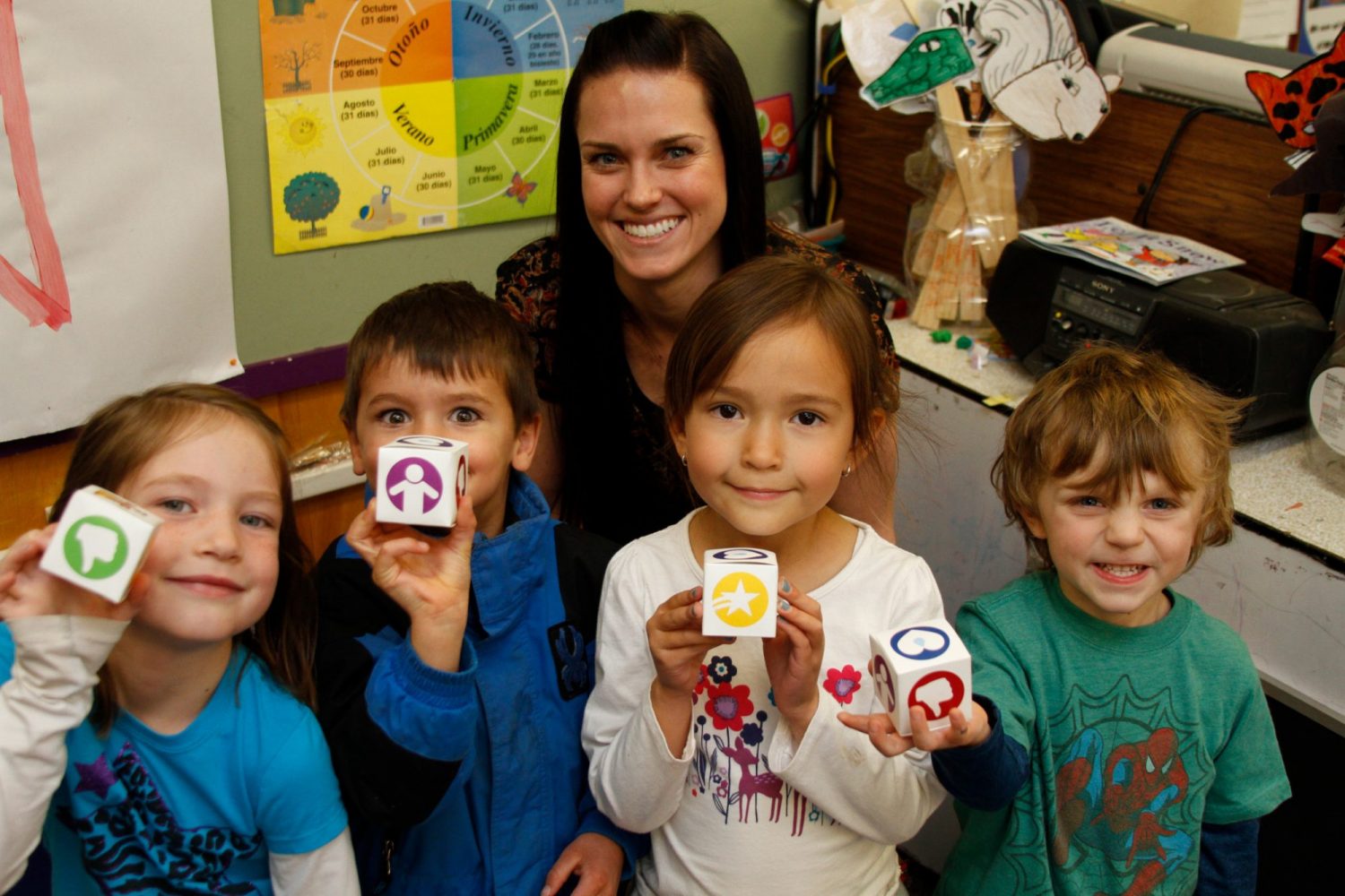 Student teacher works with young students.