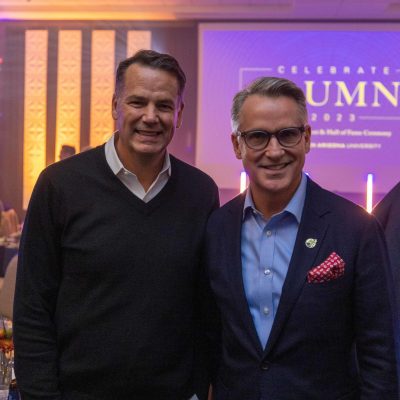 Eric Scott Baker posing with another alumnus