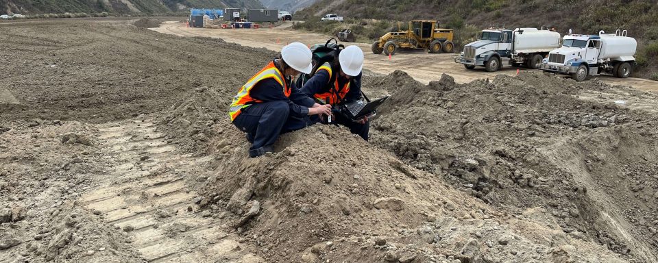 Photo of Dede Chapline and Ian Marrs carrying out remote sensing measuments at the oil field.