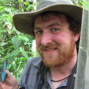 Michael Rotter in the field holding a butterfly.
