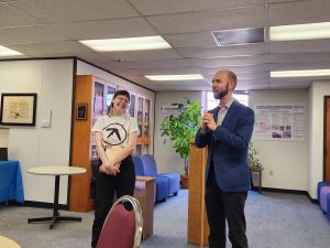 In this image, Dr. Kent Linthicum presents Joce Dolezal with her book for the junior book prize in humanities.