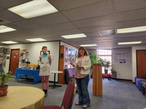 In this image, Dr. Carli Anderson presents Morgan Wood with her certificate for the Gary Kane Study Abroad Scholarship.