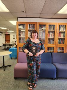 Mckenzi Monical poses with her book for the junior book prize in art history.