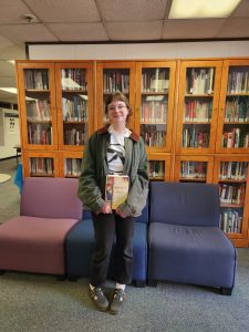 Joce Dolezal poses with her book for the junior book prize.