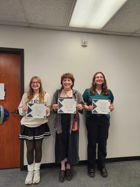 three people smile, holding certificates