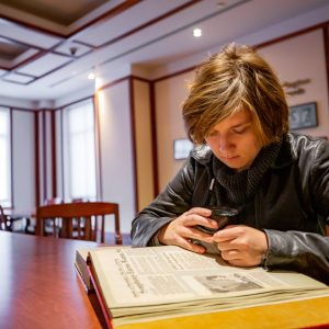 A student intern conducting research in the reading room of Cline Library Special Collections and Archives.