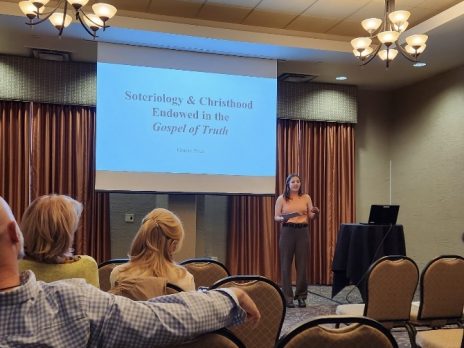 student presents in front of a project screen