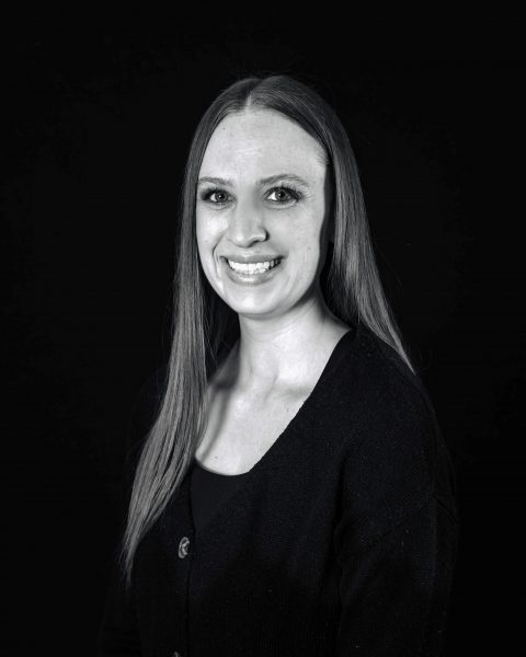 Photograph of CCS alum Dr. Emily Lawhead. A woman with long hair smiles in a black and white portrait.