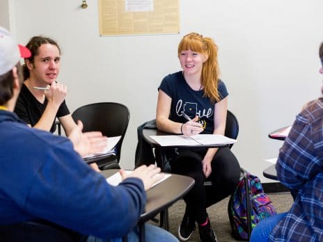 students sitting in a circle conversing during class time
