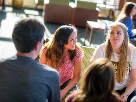 students chat in a sunny room