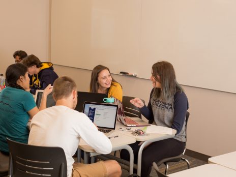 students working on computers at a table