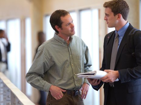 a business student talking to a professor in the business building at NAU