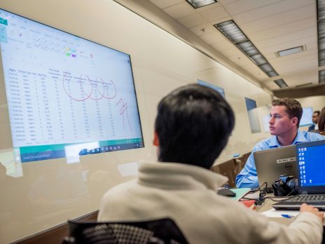 Students looking at a spreadsheet on projector.