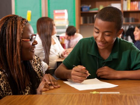 a teacher helping a young student in elementary school