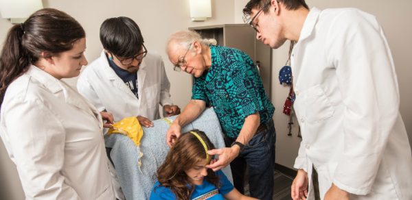 Dr. Larry Stevens with students in an EEG lab.