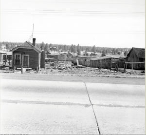 Just across Route 66 from the sawmill, was "Los Chantes" (also known as the Stanfield Slums), a sawmill worker's camp consisting of one bedroom shacks, where Jesse [Dominguez’s] father initially lived. Presently, the University Plaza Shopping Center Safeway on South Plaza Way is at this location. At the age of 17 Jesse Dominguez’s father moved to Flagstaff from Mexico after he found work at the Saginaw-Manistee Sawmill where he remained employed until his retirement. (Courtesy of NAU Special Collections)