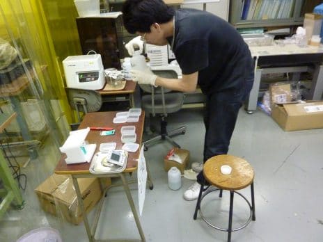 An NAU professor is working with ink and paper