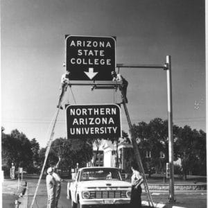 Changing of sign on the entrance sign, May, 1966.