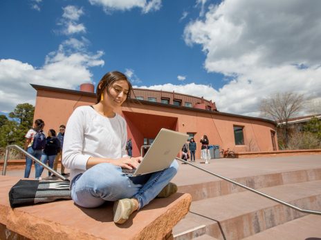 Young woman with a laptop outside
