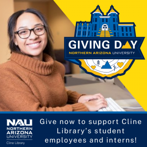 Female student smiling at the camera with hands on a computer keyboard.