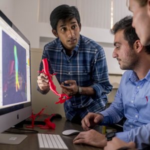 photo of nau mechanical engineering students working on a computer