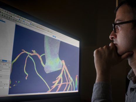 photo of a man studying an image on his computer