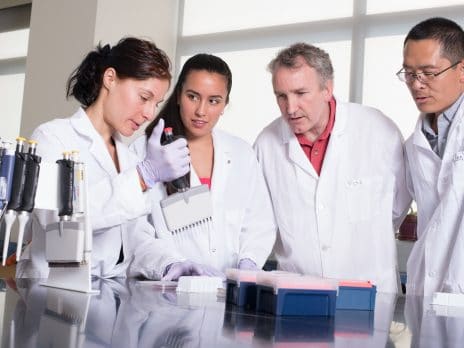 nau graduate college professors and students perform experiment in a science lab