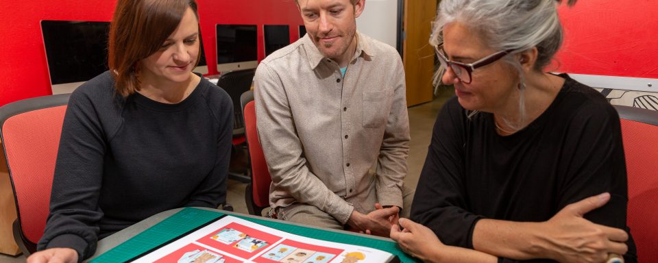 A group of faculty examining their research together
