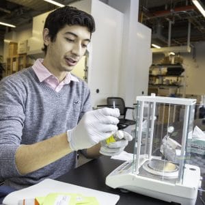 Joseph Espinoza labeling water samples in the lab