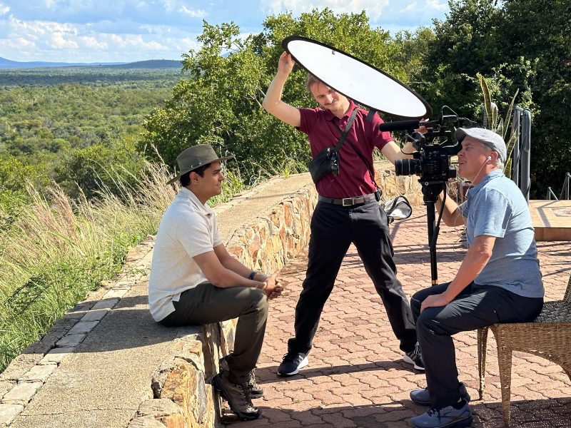 A picture of Professor Bill Carter recording Zain Patrawala, with Angel Rafael assisting with lighting