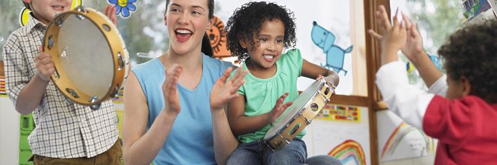 Teacher and children playing music.
