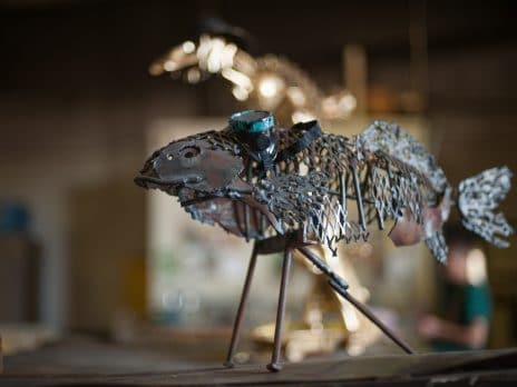 a fish sculpture made of reclaimed metal