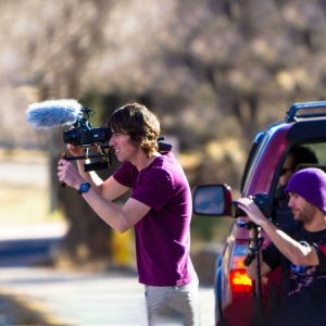 Two people filming outside.