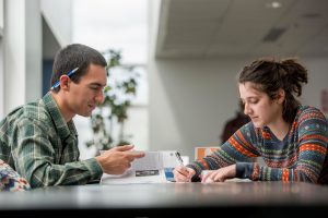 Students studying together at a table.