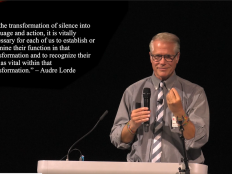 A photo of David Ragan who has short grey gair and wearing glasses and a grey shirt, against a black background. There is a quote by Audre Lorde added digitally to the photograph that reads, "In the transformation of silence into language and action, it is vitally necessary for each of us to establish or examine their function in that transformation and to recognize their role as vital within that transformation." 