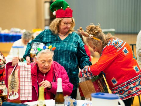 Three RSVP volunteers in holiday themed clothing