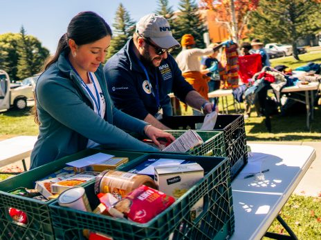 two people collecting items at a food drive