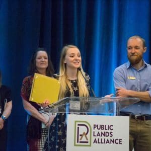 Bettymaya Foott (Center), University of Utah, and Nate Ament (Right), National Park Service, accepting the Public Lands Partner Award from the Public Lands Alliance at their annual conference and trade show in Palm Springs, CA in 2018