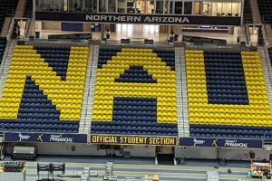 Blue stadium seats with "NAU" spelled out in gold