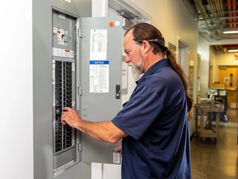 Electrician working on an electrical panel